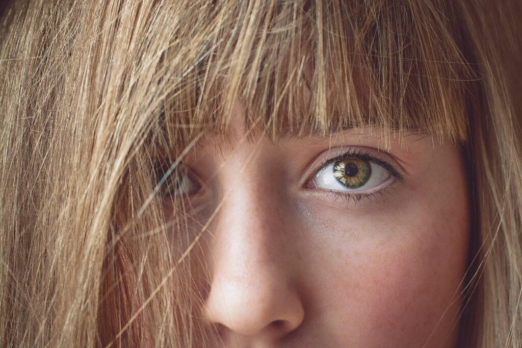 A close up of the face and nose of a young lady.