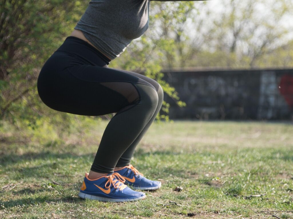 A woman performing an exercise squat.