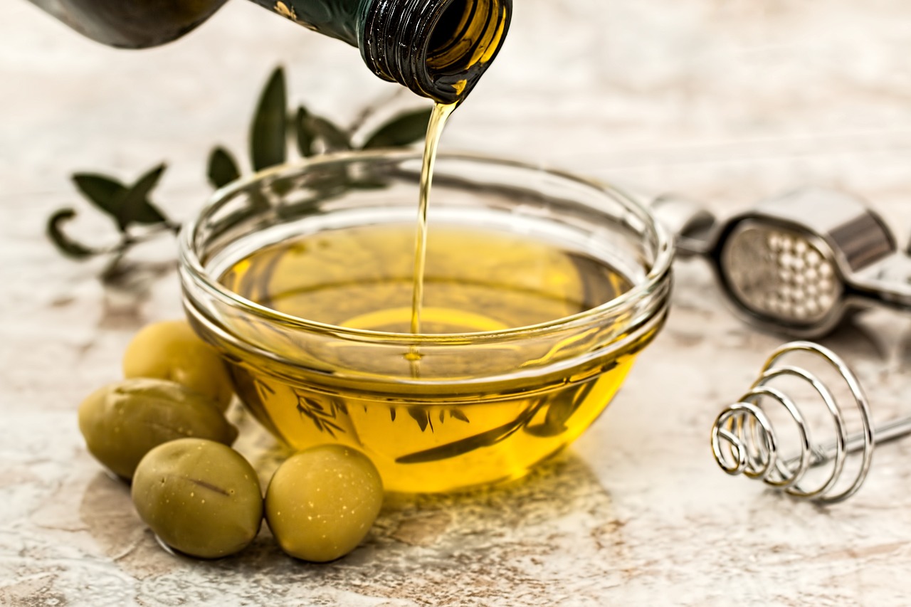 Extra virgin olive oil being poured into a bowl.