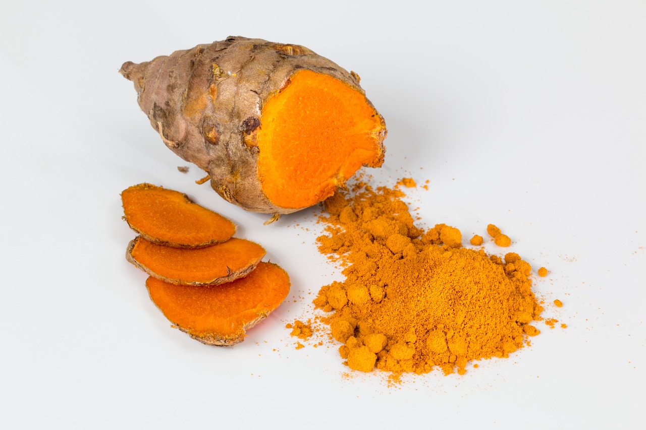 Turmeric root alongside turmeric powder