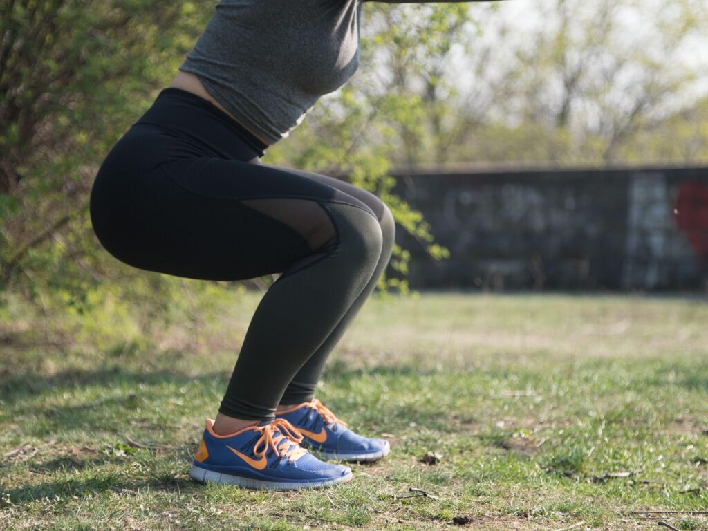 A lady performing a squat exercise.