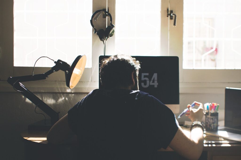 A man sitting and working at a desk.