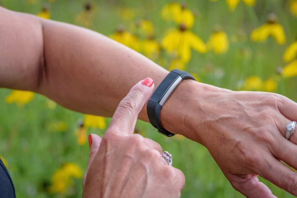 A woman tracking her daily movement using a step counter