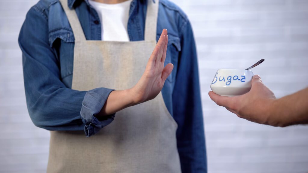 A man declining the offer of some sugar