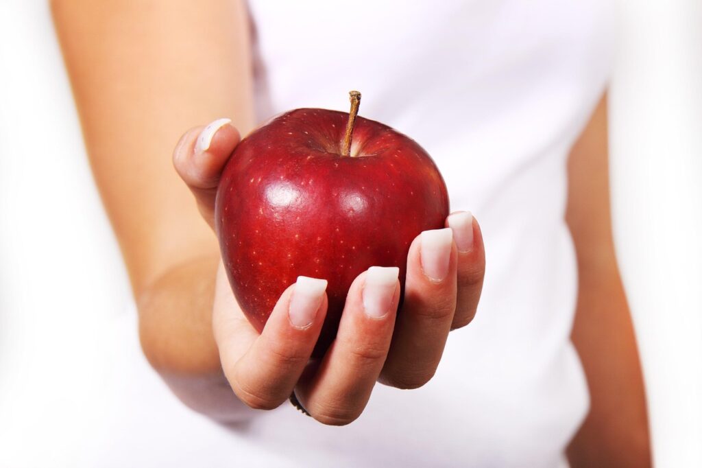 A woman holding an apple