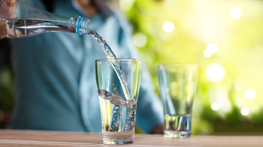 A man pouring a glass of water