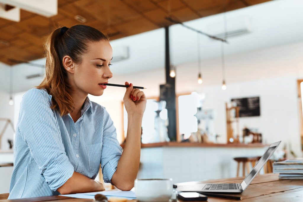 A woman learning something on a laptop.