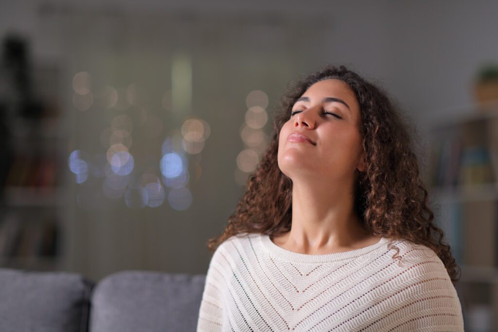 A woman practicing nasal breathing, that involves breathing in through your nose rather than through your mouth.