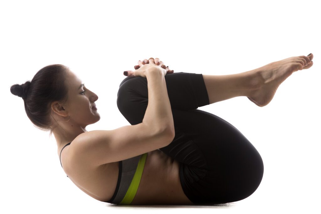 A woman performing the thread the needle back stretch