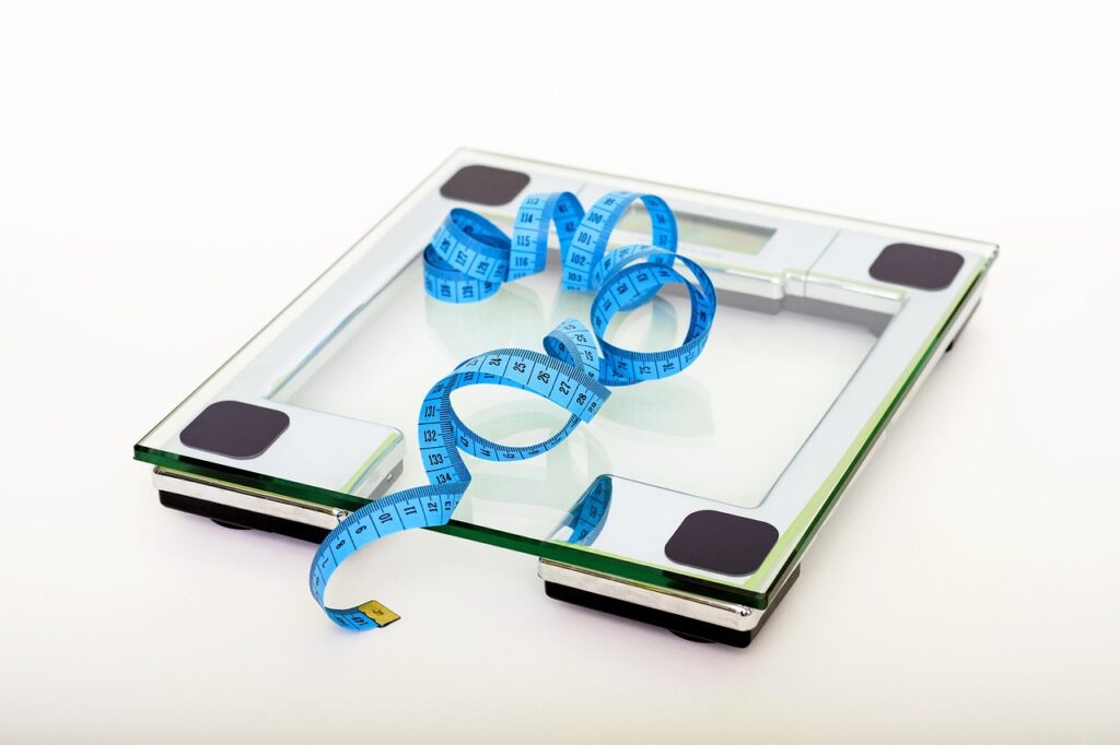 Scales and tape measure, important tools for diet and weight loss.