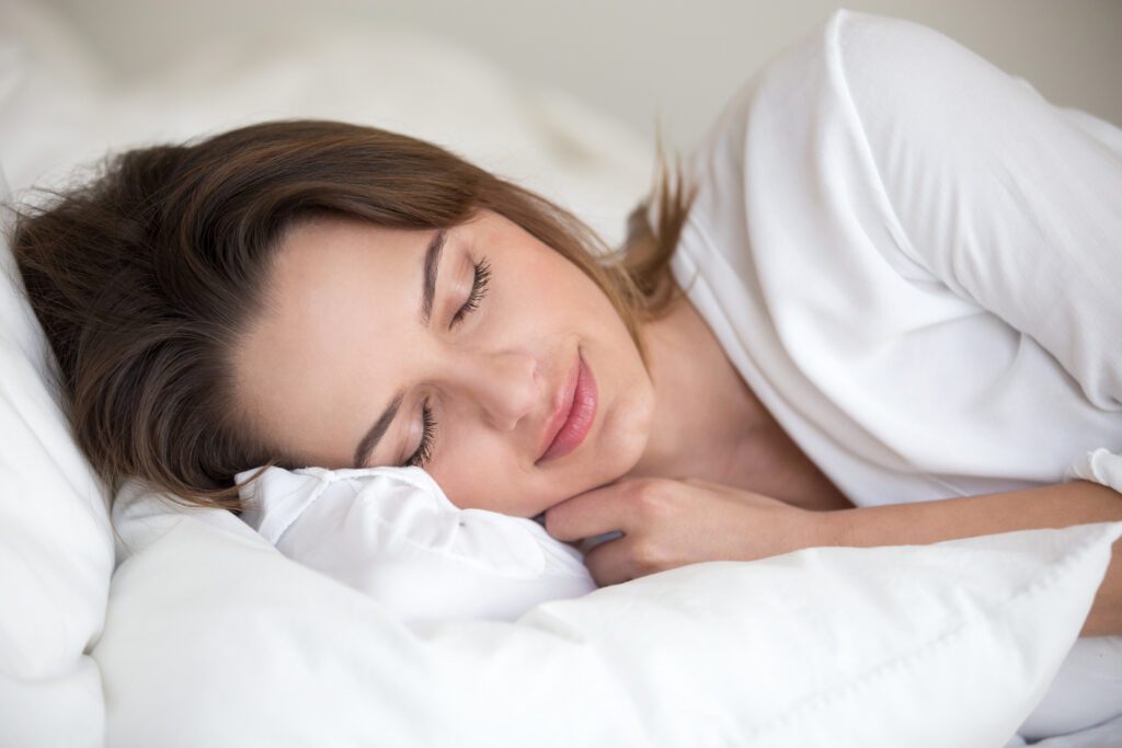 A woman sleeping peacefully in bed.
